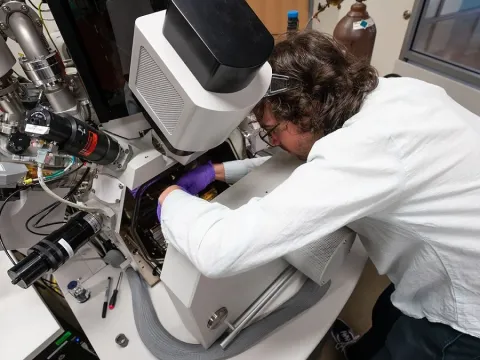 Researcher working on lab equipment.