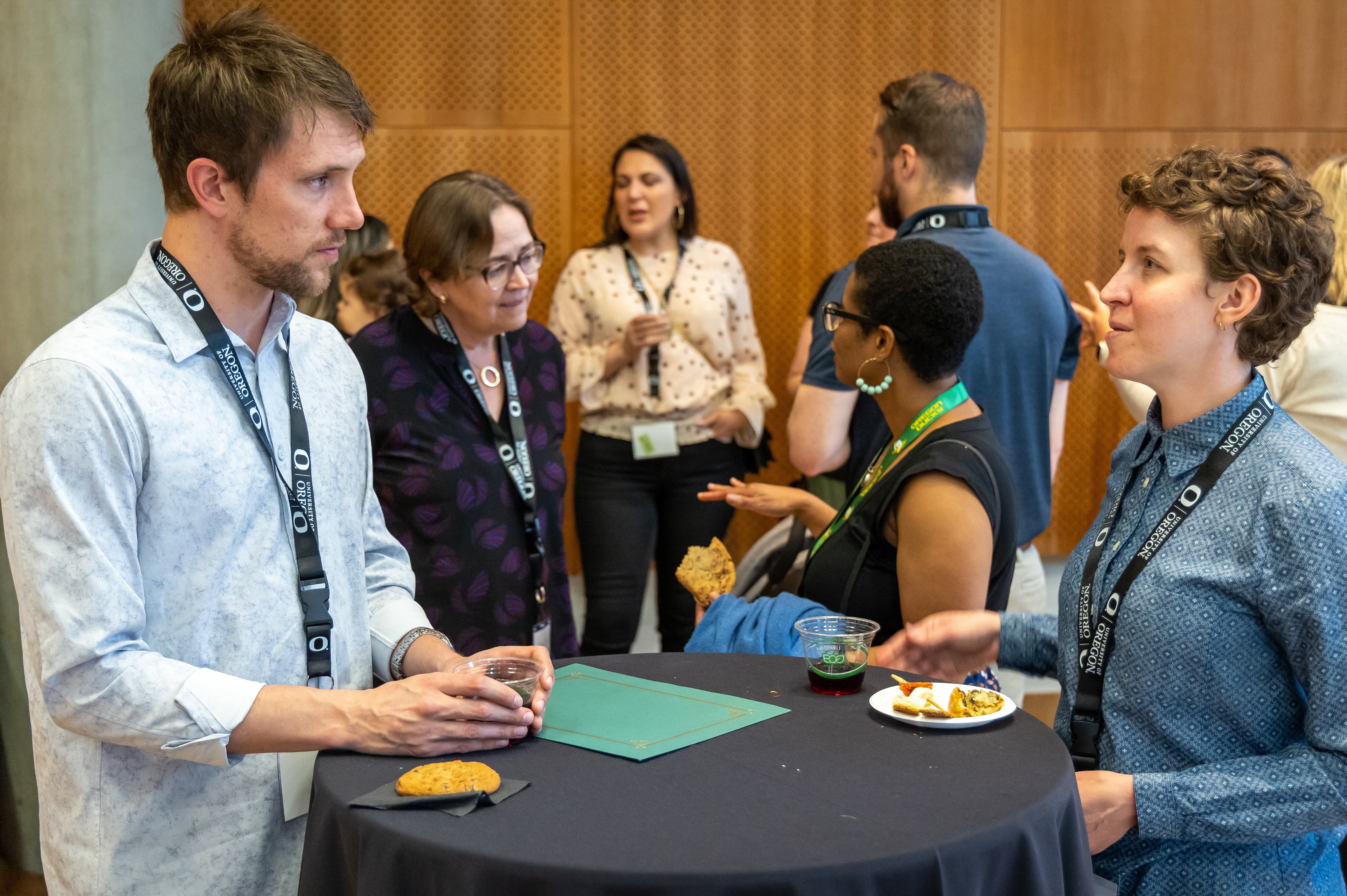 Photo of attendees talking at high-top table during WIN reception