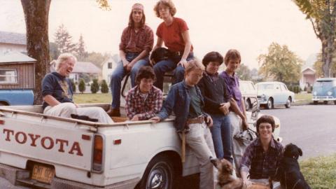 Eight women clustered around and in a Toyota pickup.