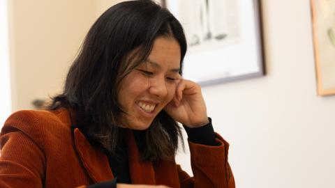 Kayla Nguyen looks down, smiling. 