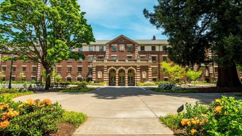 Exterior of a red brick building on a sunny spring day.