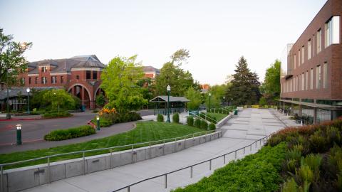 a sidewalk and a street lined with brick buildings