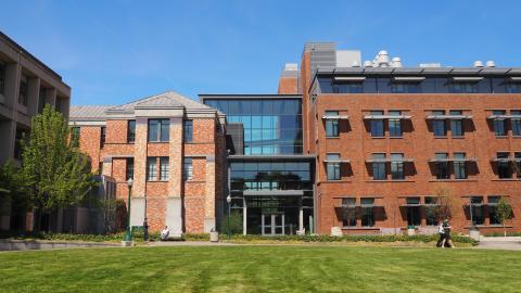 a brick building with a lawn in front