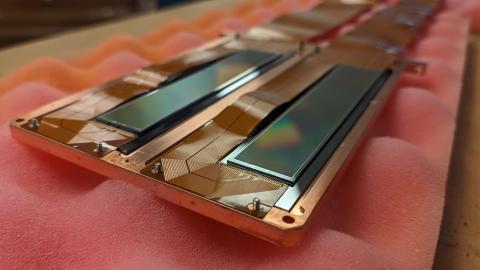 Sensors called SENSEI Skipper CCDs that used to detect sub-GeV dark matter candidates rest on foam.