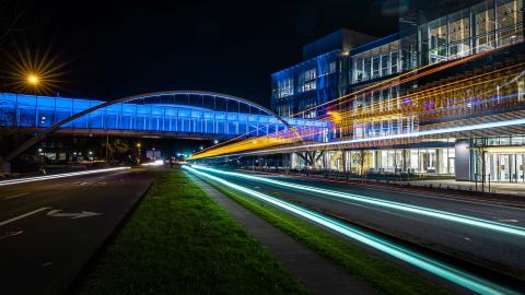 A nighttime image of the Phil and Penny Knight Campus building one.