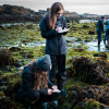 Maddy Rusk and Katie Richardson, both seniors in the marine biology program, take notes to catalogue their finds during tidepooling.