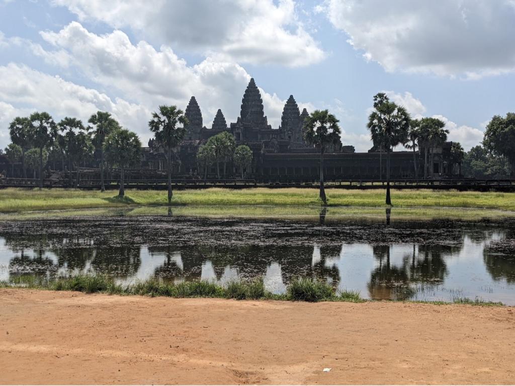 The temple of Angkor Wat is seen from across a body of water.