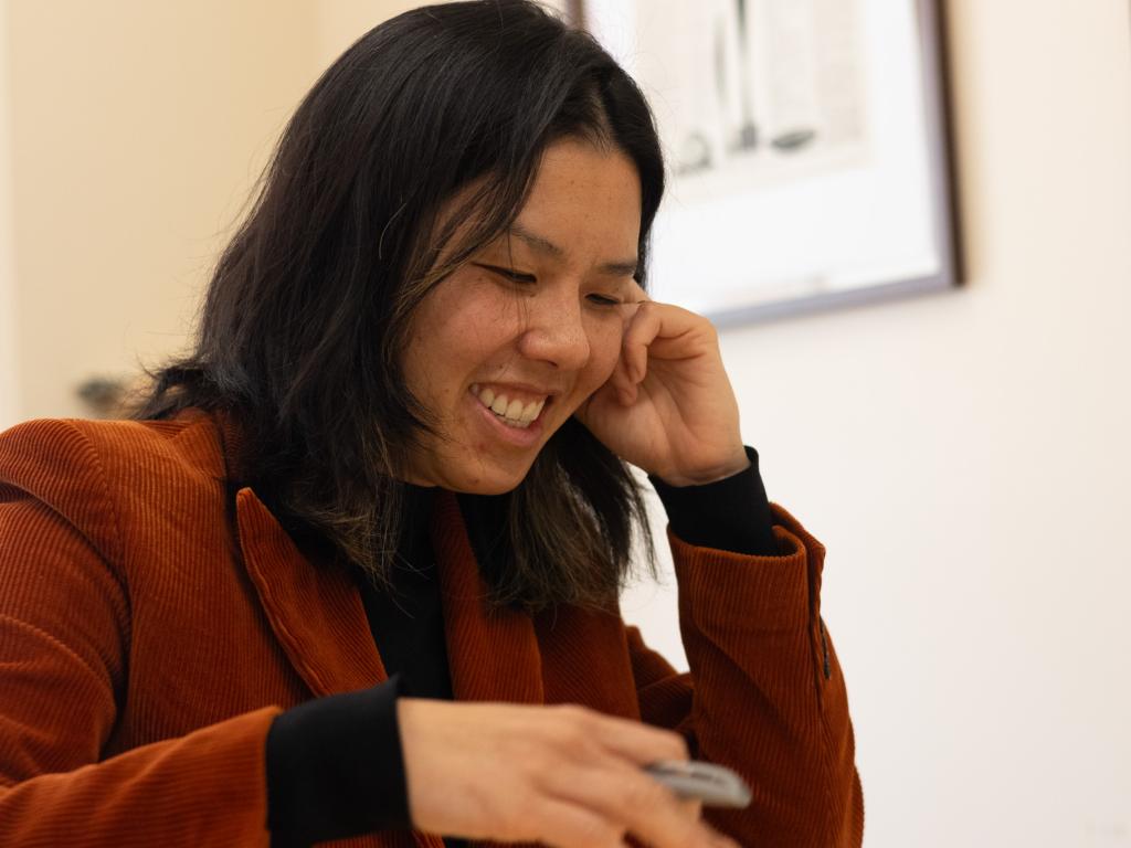Kayla Nguyen looks down, smiling.