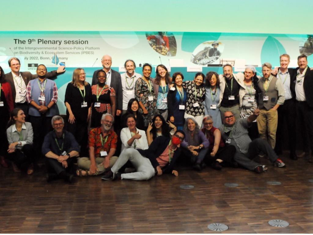 A large group of people pose together