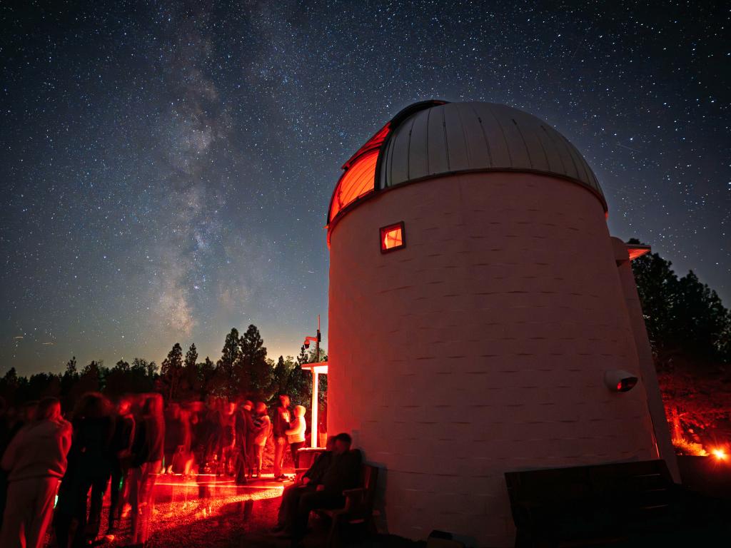 Pine mountain observatory with people outside looking at the night sky.
