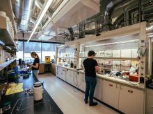 Two students work in a chemistry lab.