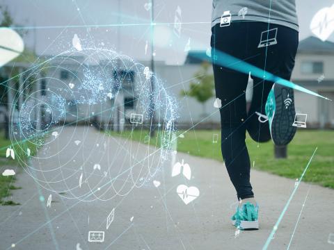 A person jogging on a pathway with digital graphics overlaying the image.