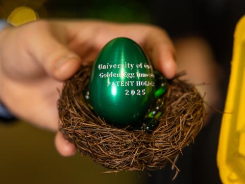 A metallic green egg inscribed with University of Oregon Golden Egg Innovator Patent Holder 2025.