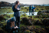 Maddy Rusk and Katie Richardson, both seniors in the marine biology program, take notes to catalogue their finds during tidepooling.