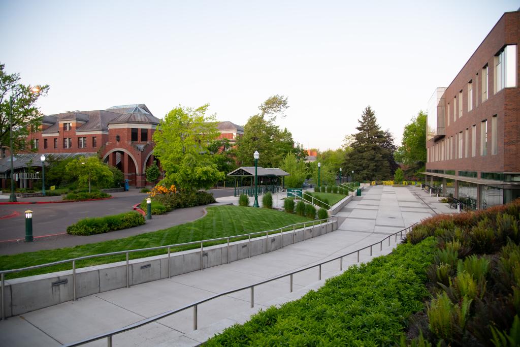 a sidewalk and a street lined with brick buildings