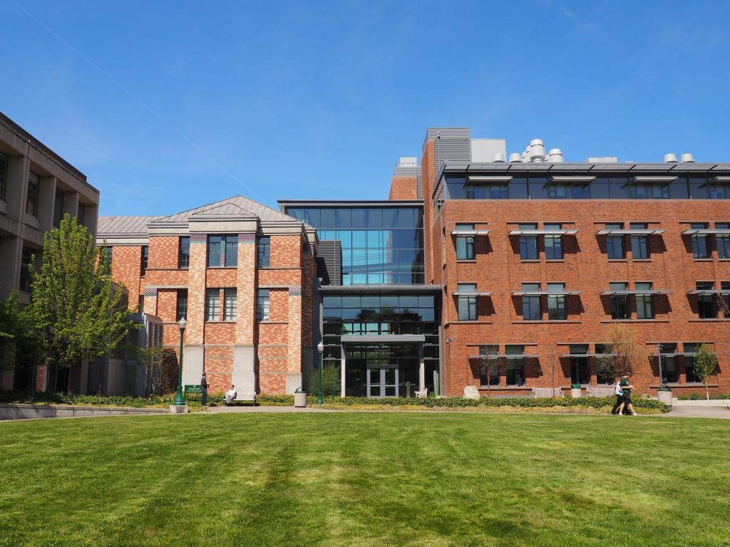 a brick building with a lawn in front