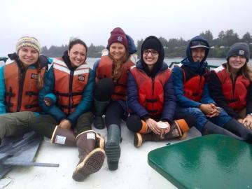 Six University of Oregon students on a boat off the Oregon Coast.