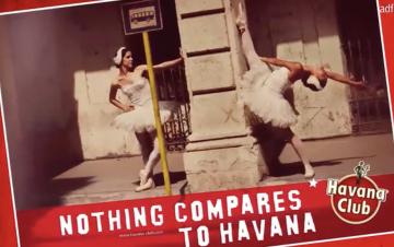 An ad for Havana Club rum featuring two ballerinas posing against a concrete pillar of a building.