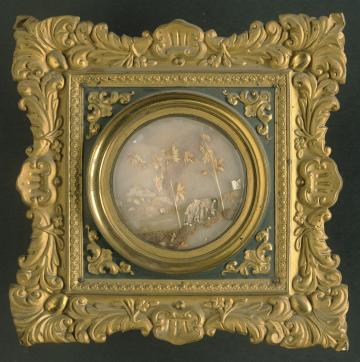 A small landscape made of human hair in an ornate gold frame.