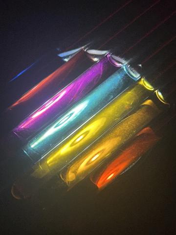 Brightly colored tubes in shades of blue, red, magenta, teal, yellow, orange,and red.