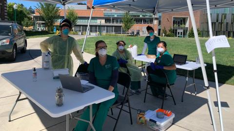 COVID-19 Monitoring and Assessment Field Team under pop up tents