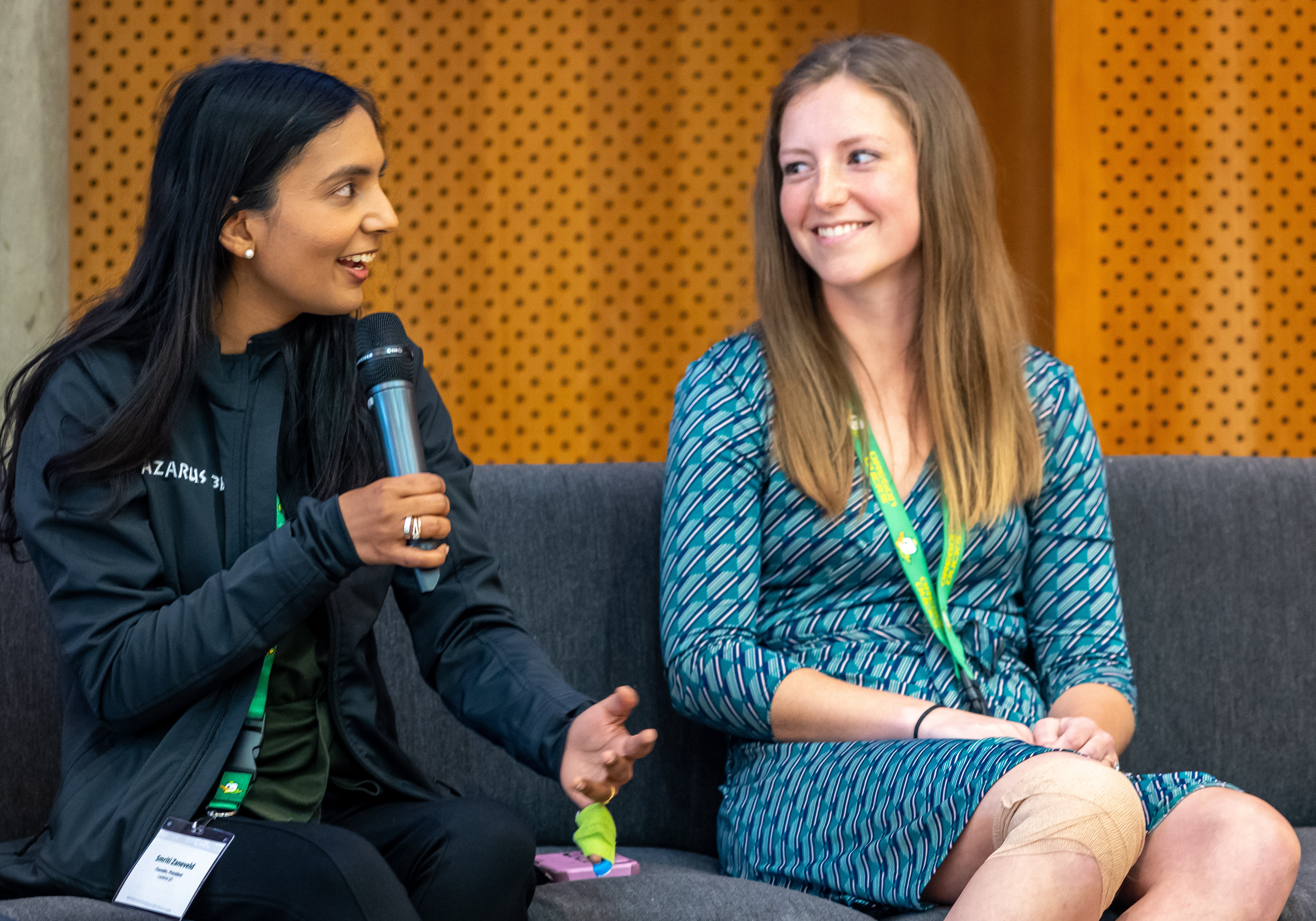 Photo of WIN mentor Smriti Zaneveld holding a microphone and talking with WIN participant Kylie Nash