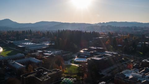 The sun rises over the University of Oregon campus.