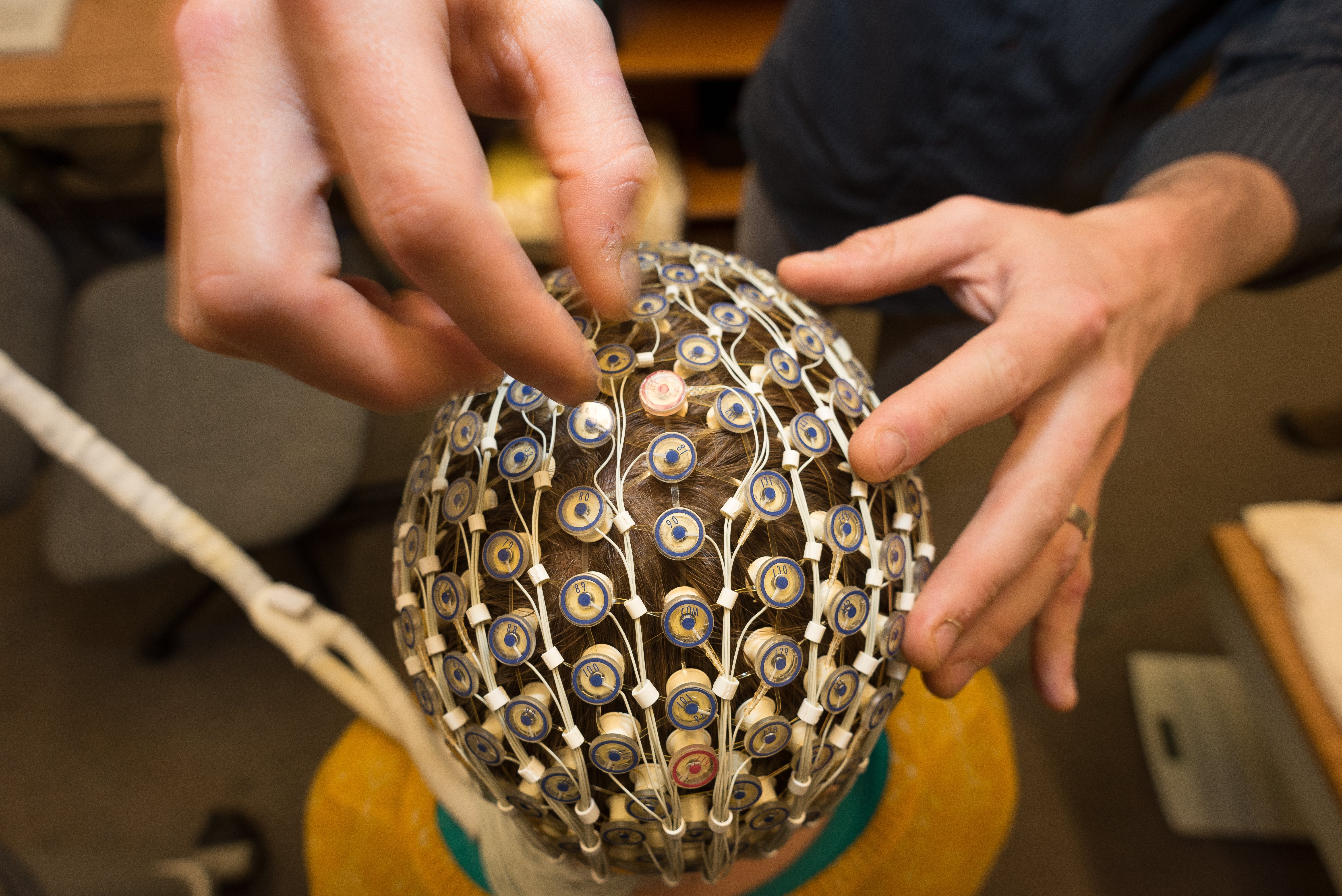sensor net on head and being inspected